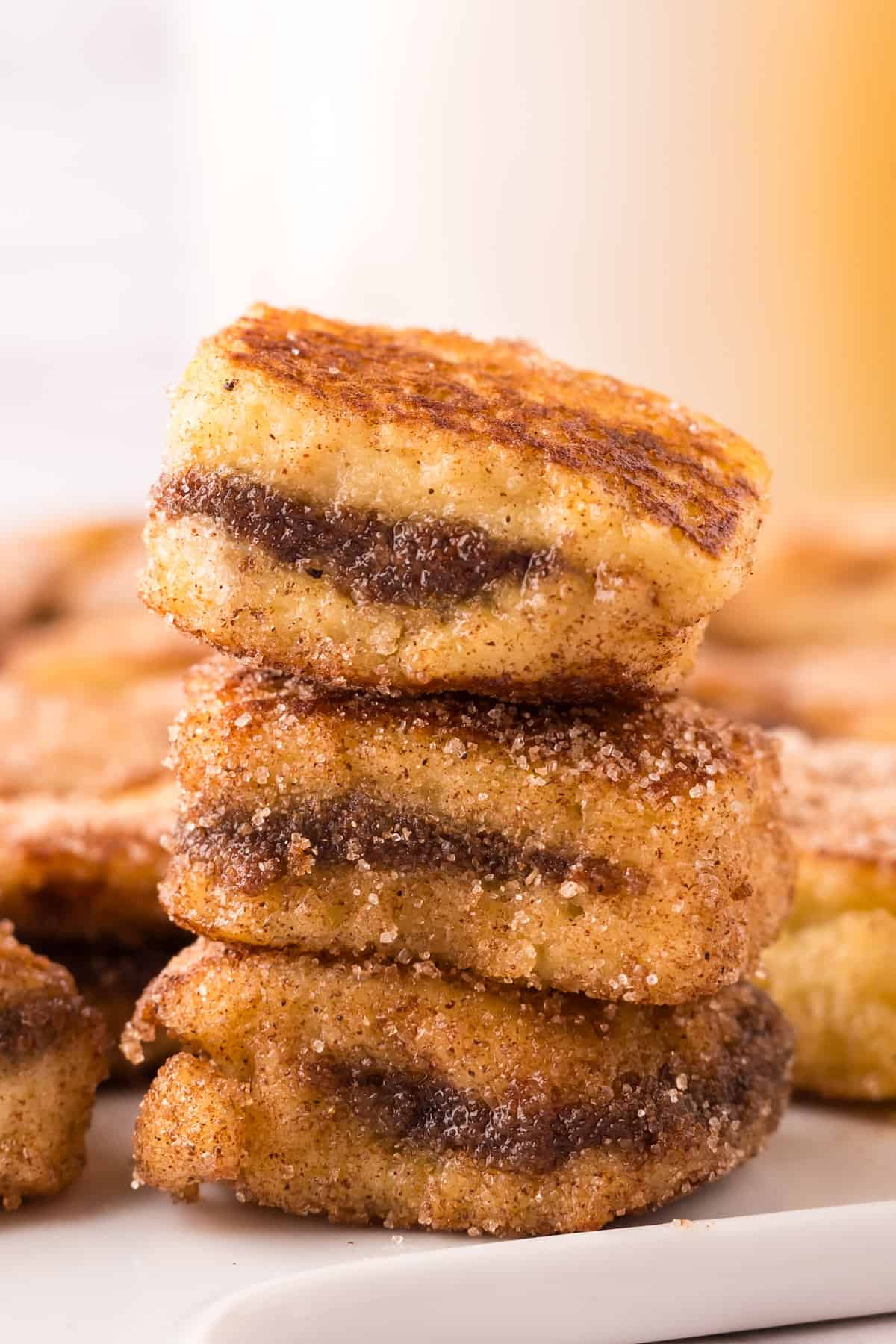 A stack of stuffed french toast bites on a plate.