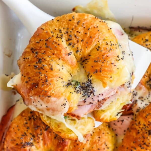 Ham and cheese croissants in a baking dish.