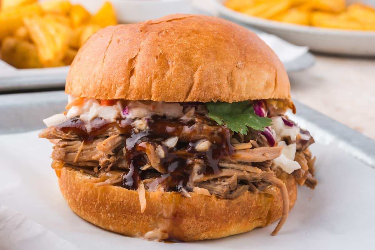A close up of the best smoked pulled pork sandwich.