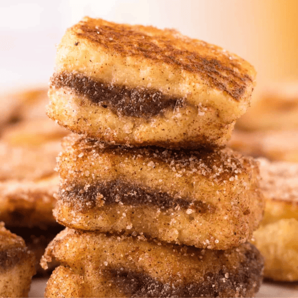 A stack of cinnamon raisin French toast bites on a plate.