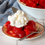 pie with strawberries on it and cream