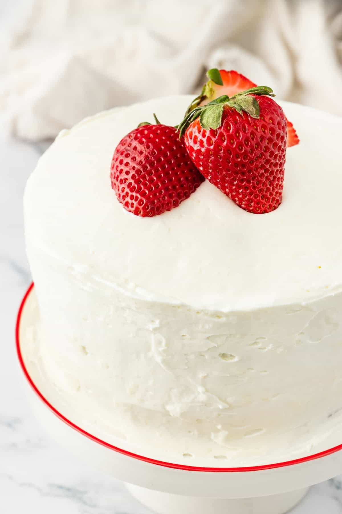 white frosted cake with strawberries