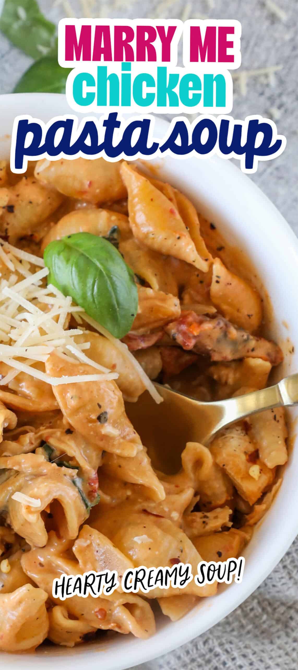 Bowl of pasta soup with chicken, topped with basil and grated cheese. Text overlay reads, "MARRY ME chicken pasta soup" and "HEARTY CREAMY SOUP!.