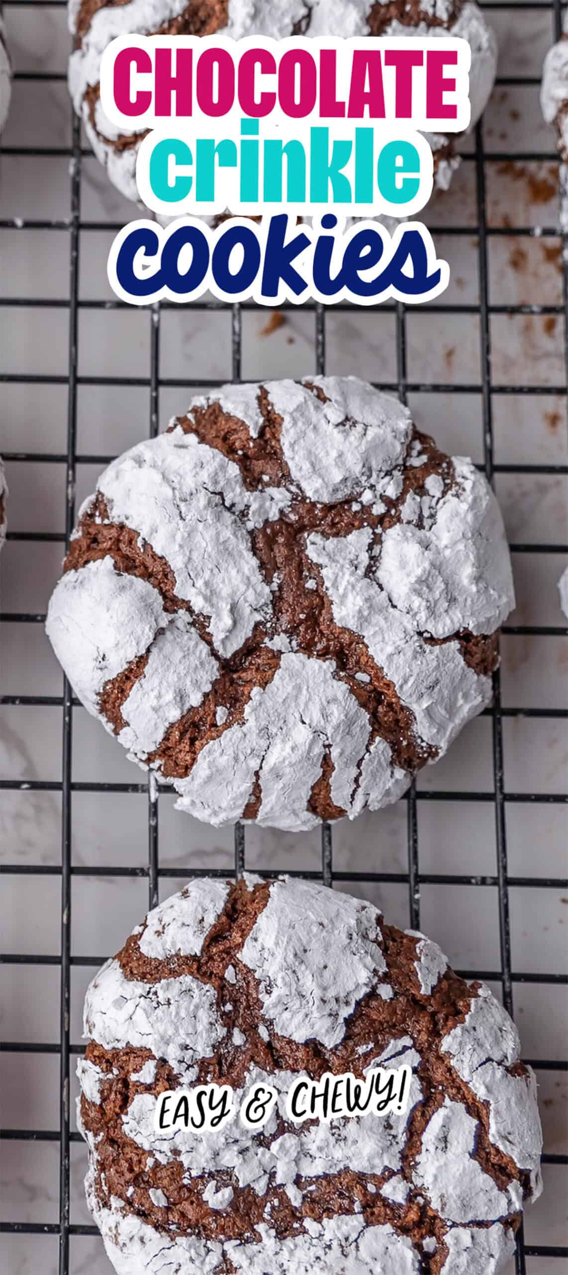 Chocolate crinkle cookies rest on a cooling rack, generously dusted with powdered sugar. The text reads: "Easy & Chewy!