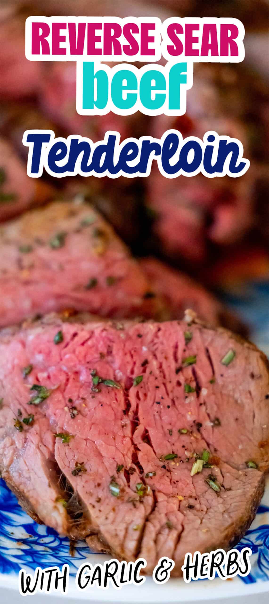 Close-up of sliced reverse-sear beef tenderloin, cooked to medium-rare perfection, and elegantly garnished with garlic and herbs. Text overlay reads "Reverse Sear Beef Tenderloin with Garlic & Herbs.