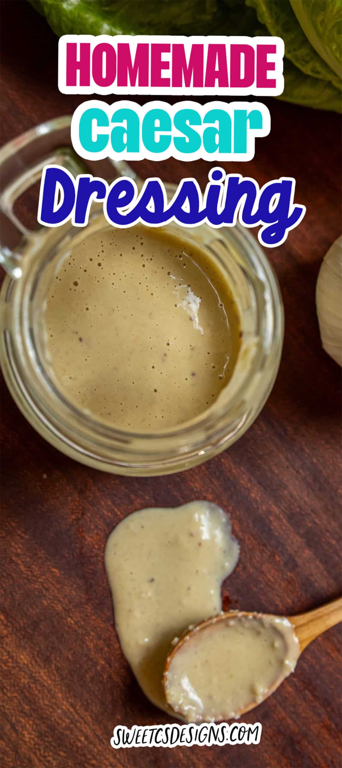 Glass jar and wooden spoon with creamy caesar dressing on a wooden surface, a bit spilling from the spoon; text reads "Homemade Caesar Dressing.
