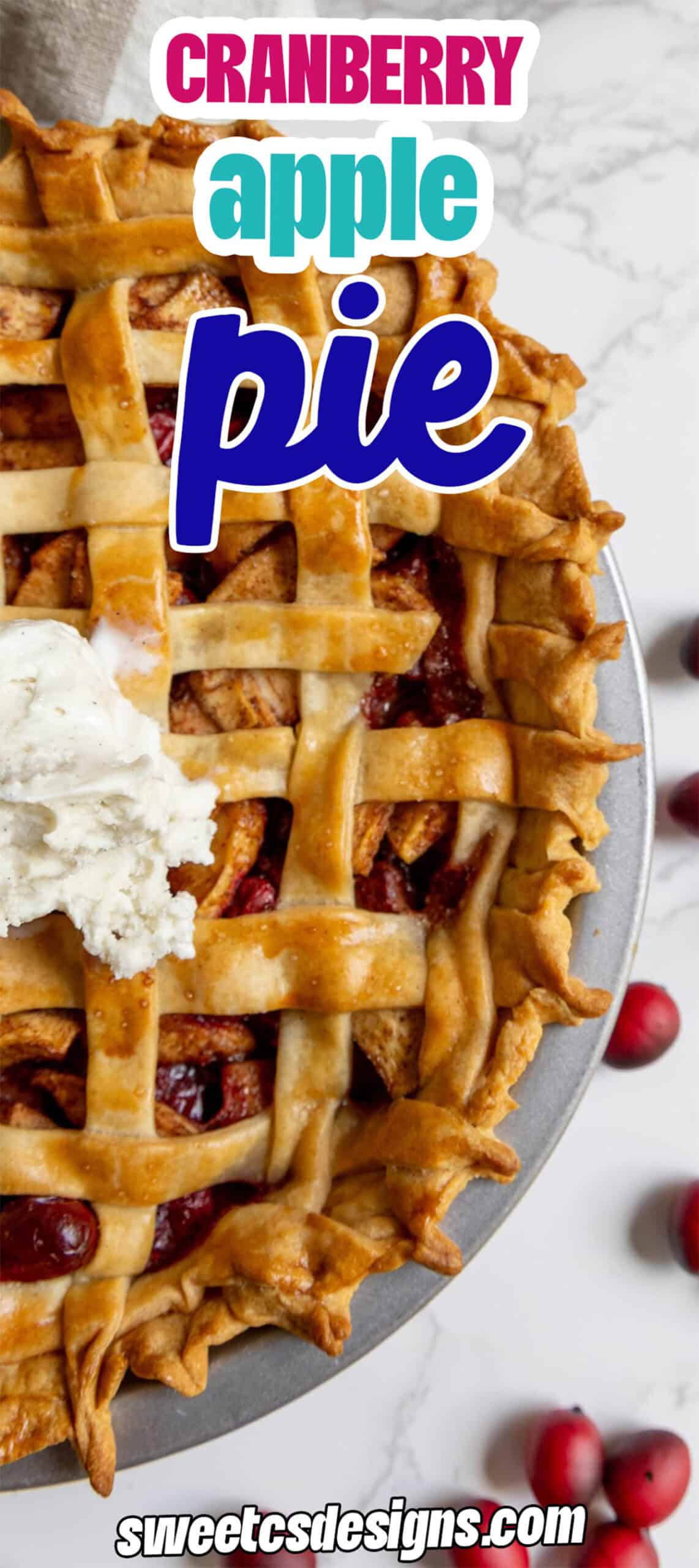 Top view of a cranberry apple pie with a lattice crust, a scoop of ice cream, and fresh cranberries on a marble surface. Text overlay reads "Cranberry apple pie.