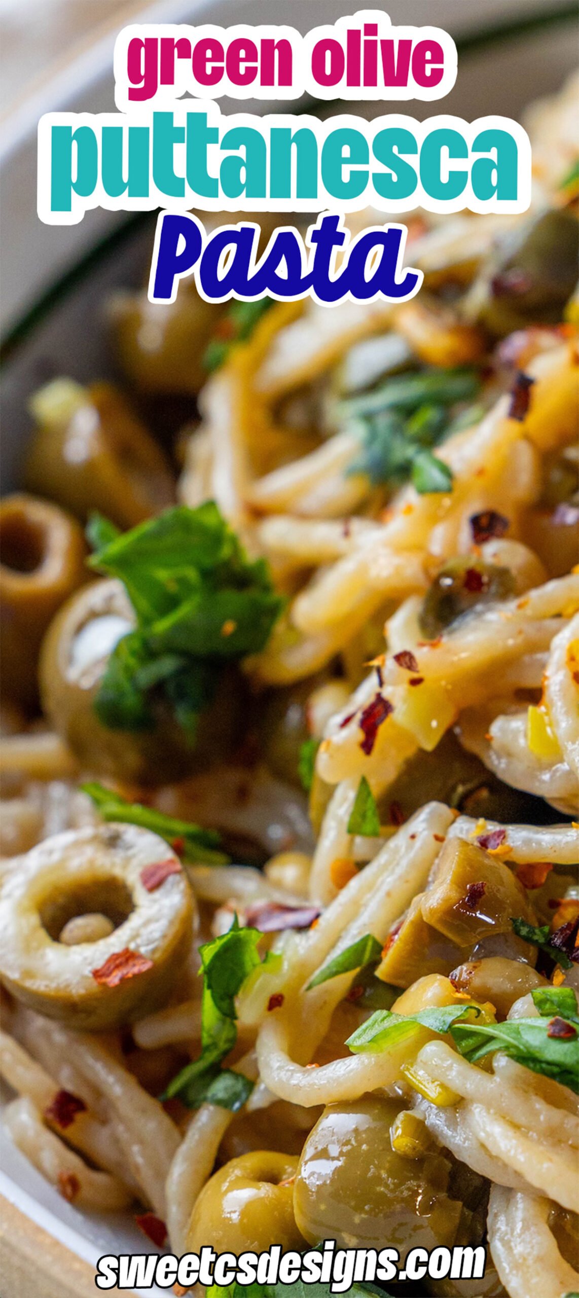 Close-up of puttanesca pasta with green olives, garnished with herbs and red pepper flakes, with the text “green olive puttanesca pasta” and “sweetcsdesigns.com” overlaid.