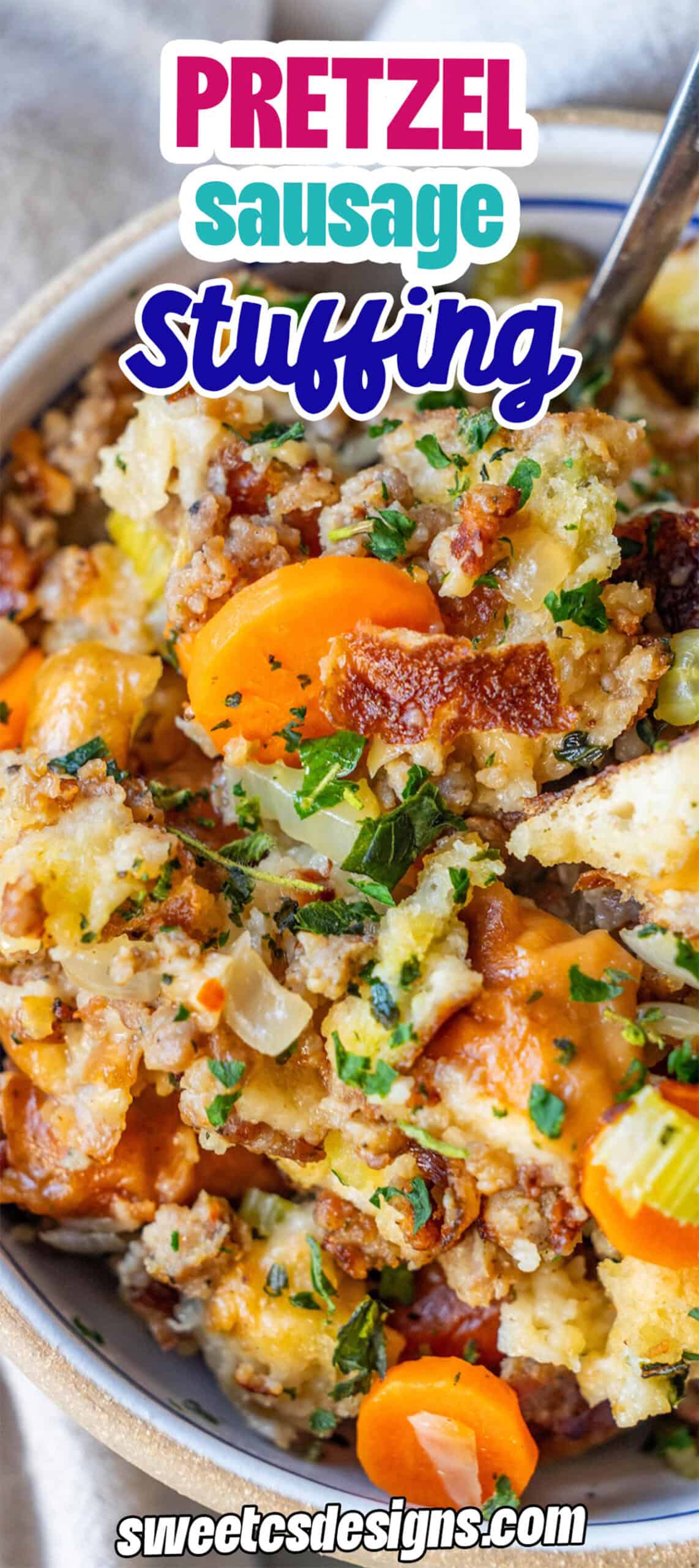 A close-up of Pretzel Sausage Stuffing with visible pieces of sausage, chopped carrots, celery, and parsley in a bowl.