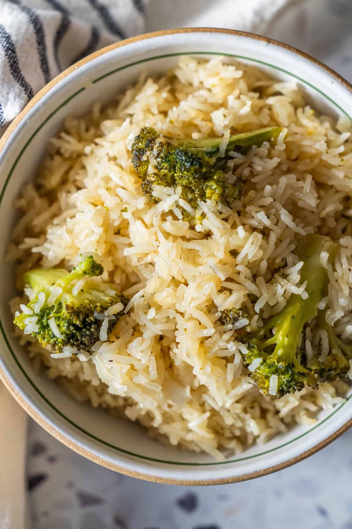 A bowl of Baked Ranch Rice mixed with fresh broccoli florets, viewed from above.