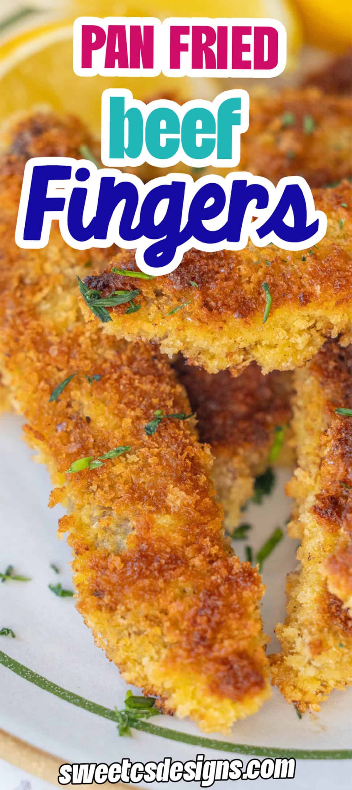 Close-up of crispy, golden-brown steak fingers garnished with herbs and served with lemon slices on a white plate—a delicious steak fingers recipe to savor.
