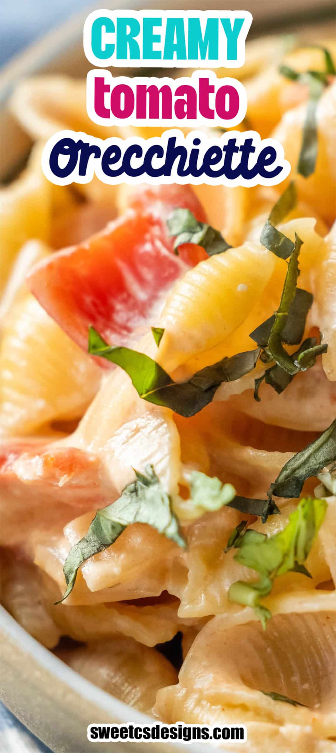 Close-up of orichette pasta in a creamy tomato sauce, garnished with chopped fresh basil.