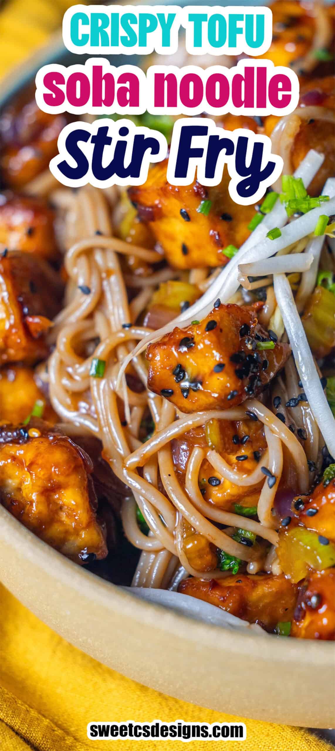 Close-up of a bowl of soba noodles stir fry with crispy tofu, bean sprouts, and green onions, garnished with black sesame seeds. Text overlay reads "Crispy Tofu Soba Noodle Stir Fry.