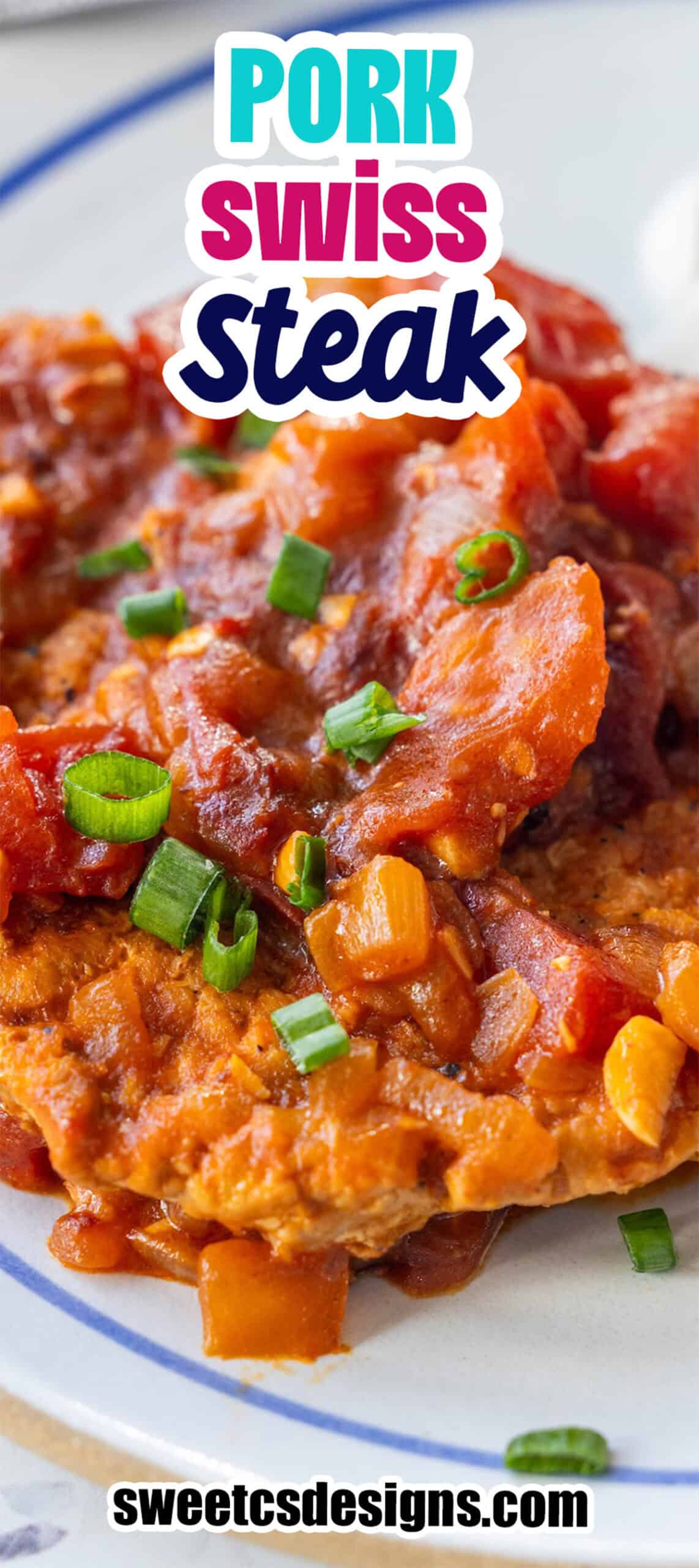 Close-up of Pork Swiss Steak topped with a rich tomato-based sauce and chopped green onions on a plate, with text overlay "Pork Swiss Steak" and "sweetcsdesigns.com".