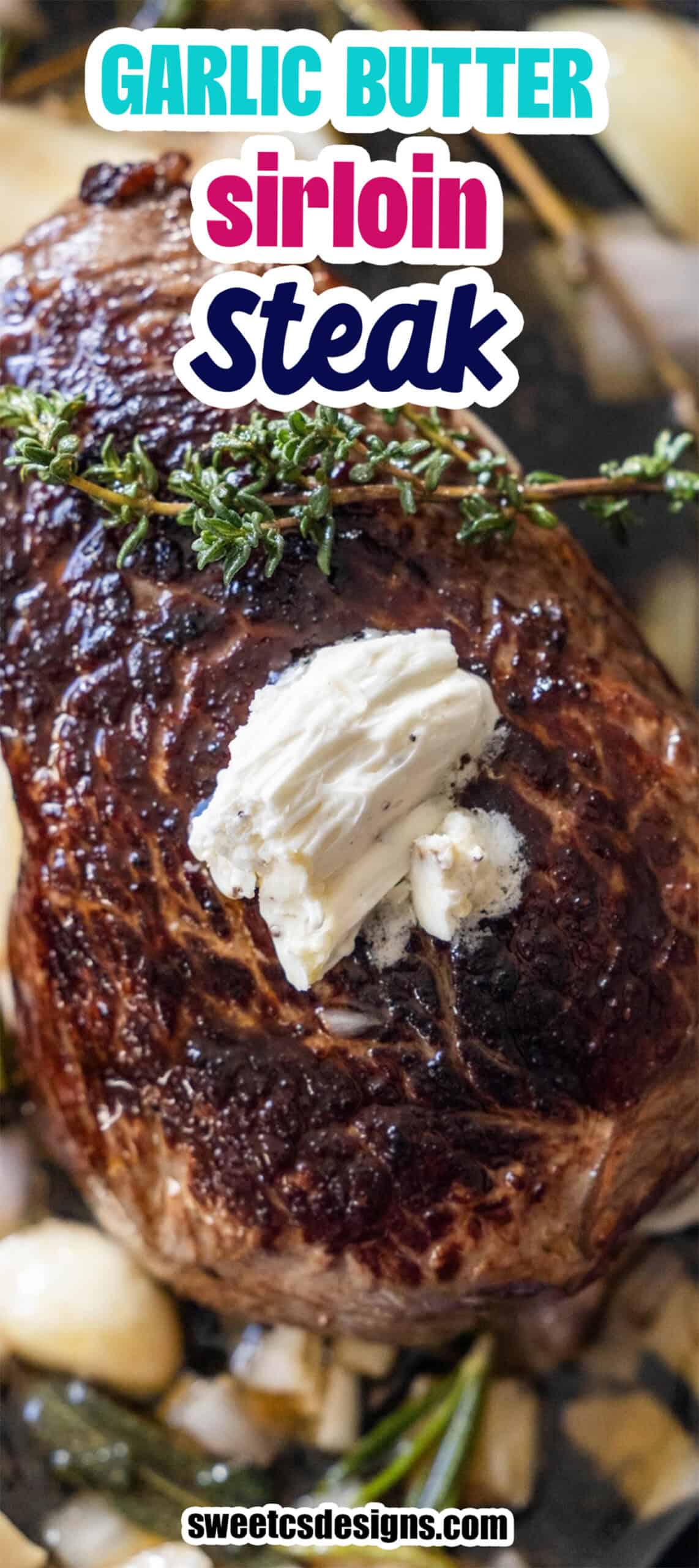 Close-up of a Garlic Herb Sirloin steak topped with a dollop of garlic butter and garnished with fresh herbs.