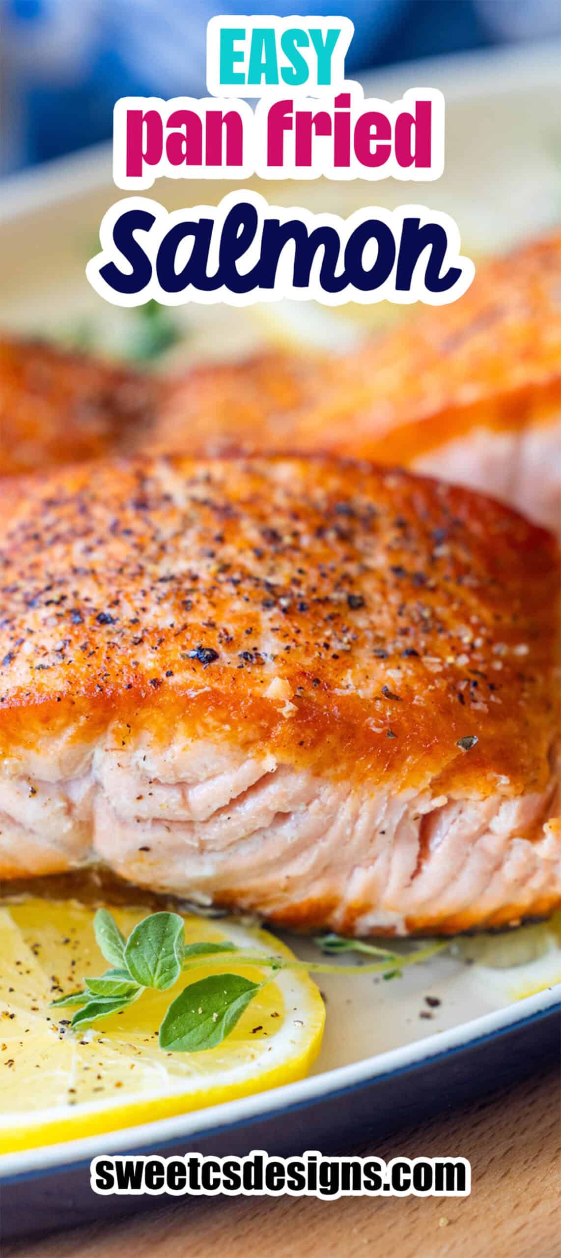 Close-up of crispy pan fried salmon filets seasoned with pepper, served on a plate with lemon slices and herbs. Text overlay reads "Easy Pan Fried Salmon Filets.