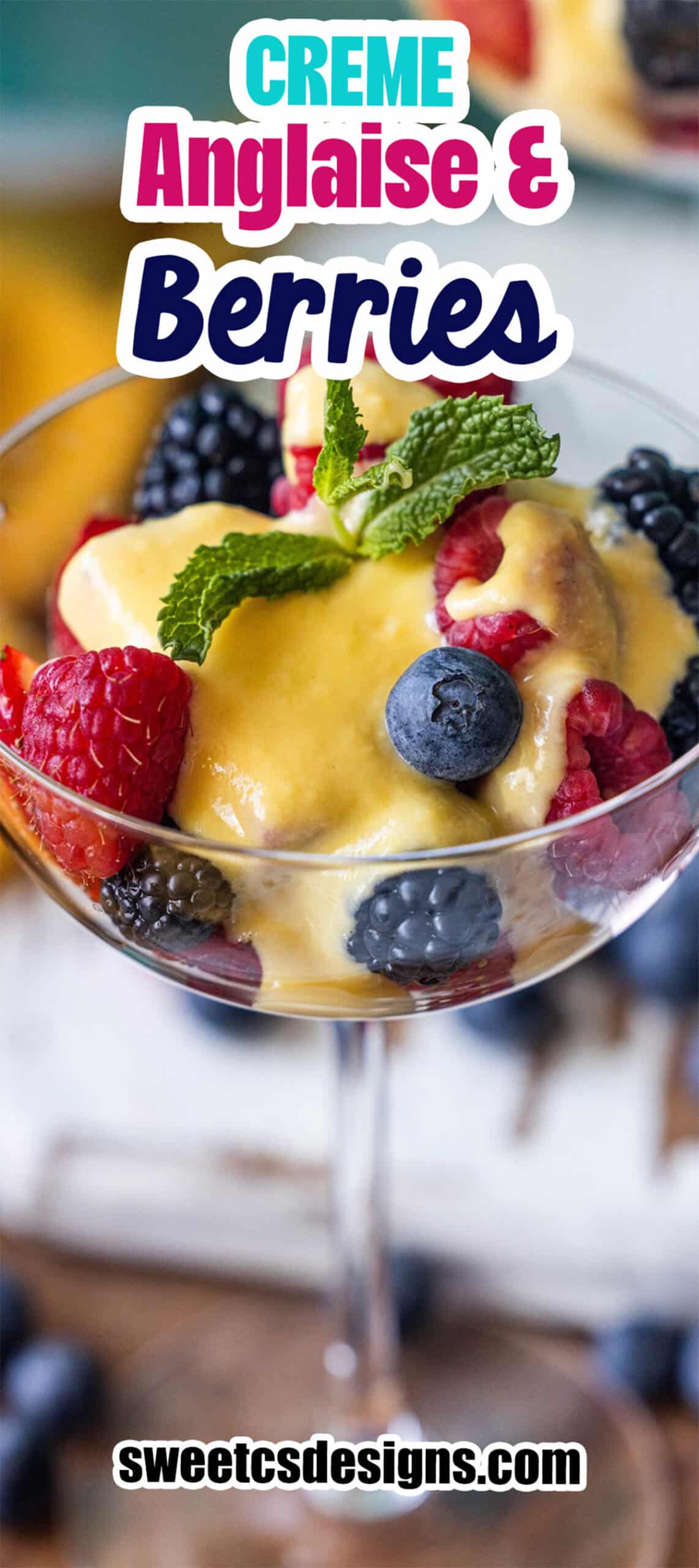 A glass filled with fresh raspberries, blackberries, and blueberries topped with yellow crème anglaise and a mint garnish. Text reads "Berries and Creme Anglaise" and "sweetcsdesigns.com".
