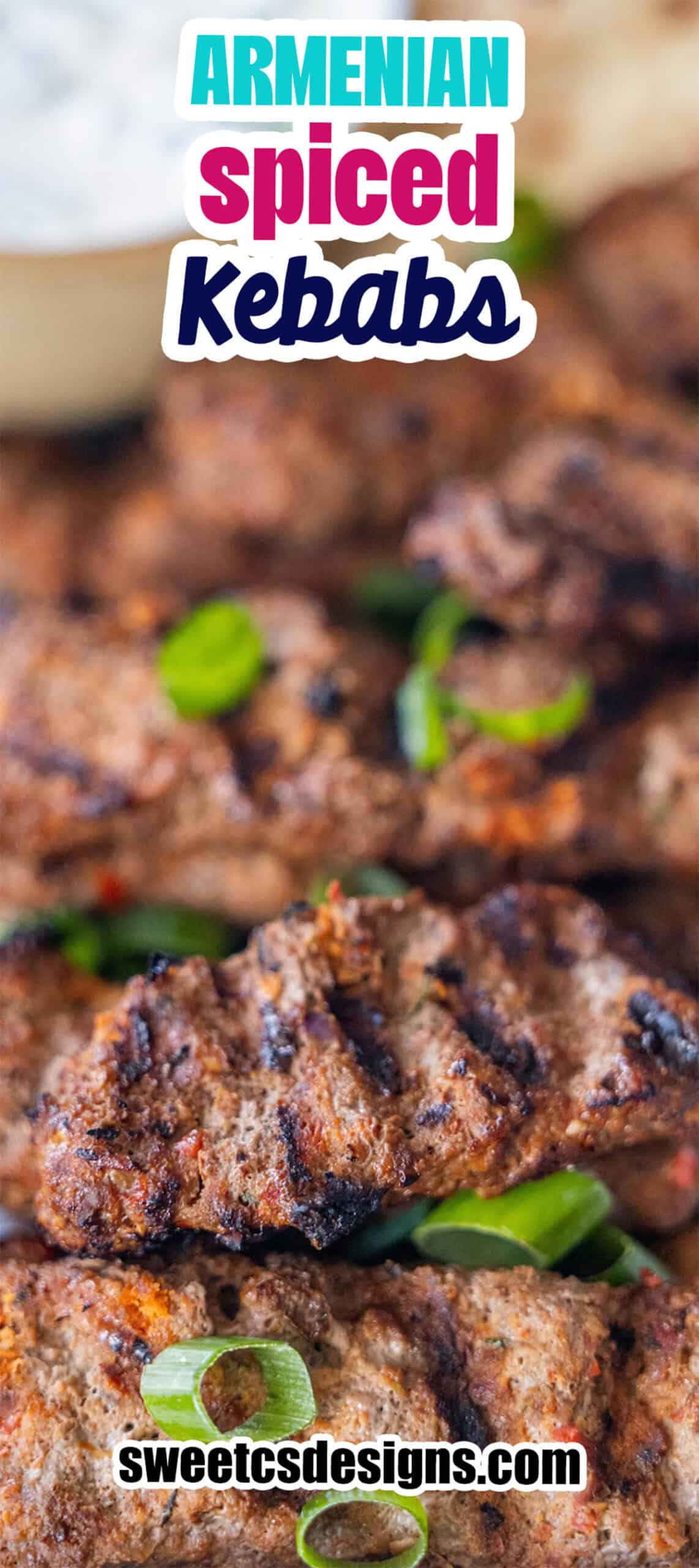 Grilled Armenian kebabs made with spiced meat, garnished with sliced green onions, shown close-up with a blurred background.