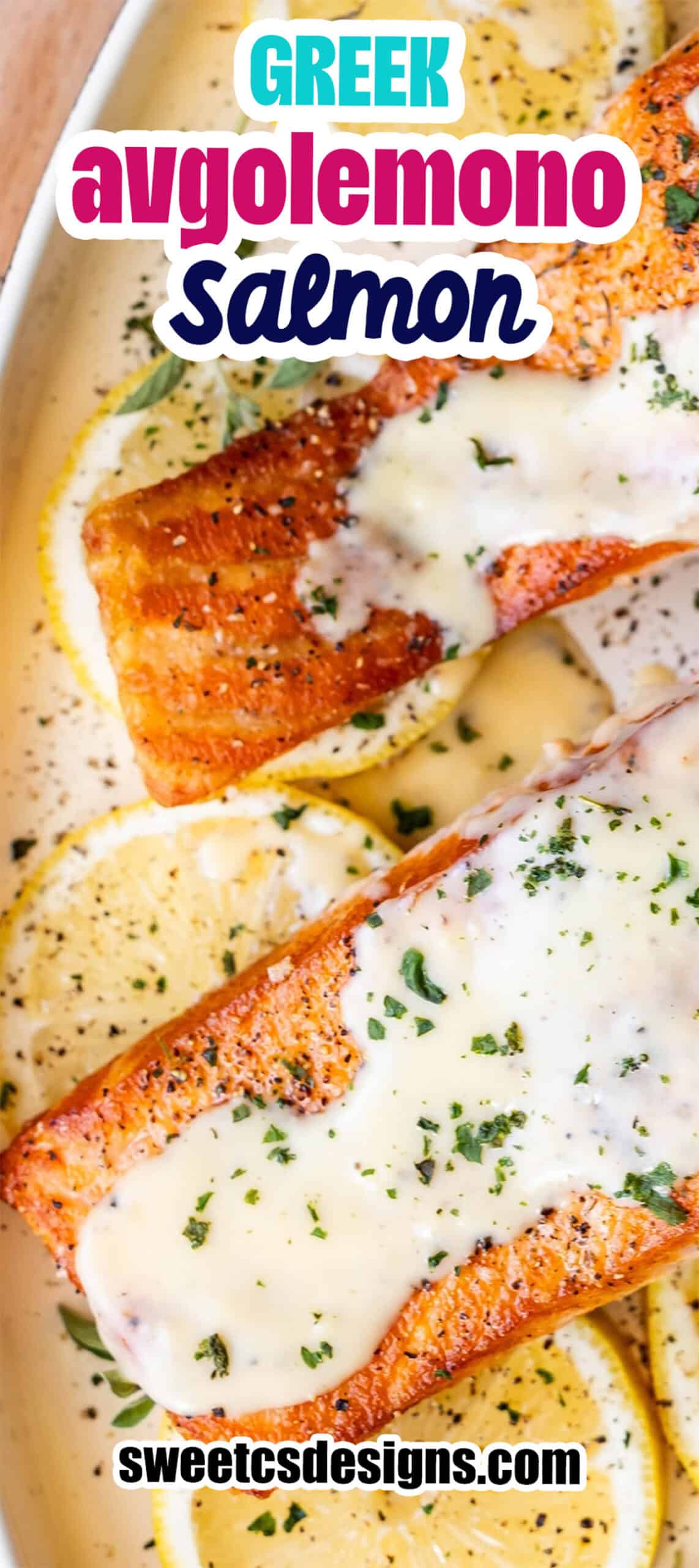 Two Greek Salmon fillets topped with creamy avgolemono sauce, garnished with herbs, served on a bed of lemon slices.