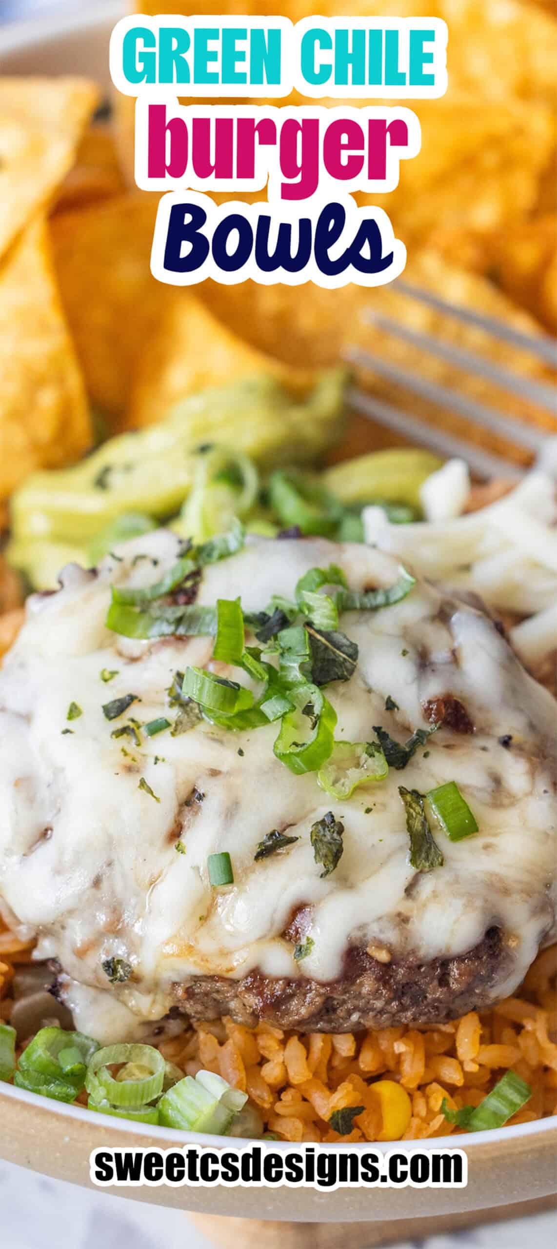 A cheeseburger patty topped with melted cheese and green onions sits on a bed of rice, creating a delicious Burger Bowl with hints of green chile, served alongside chips and guacamole in the background.