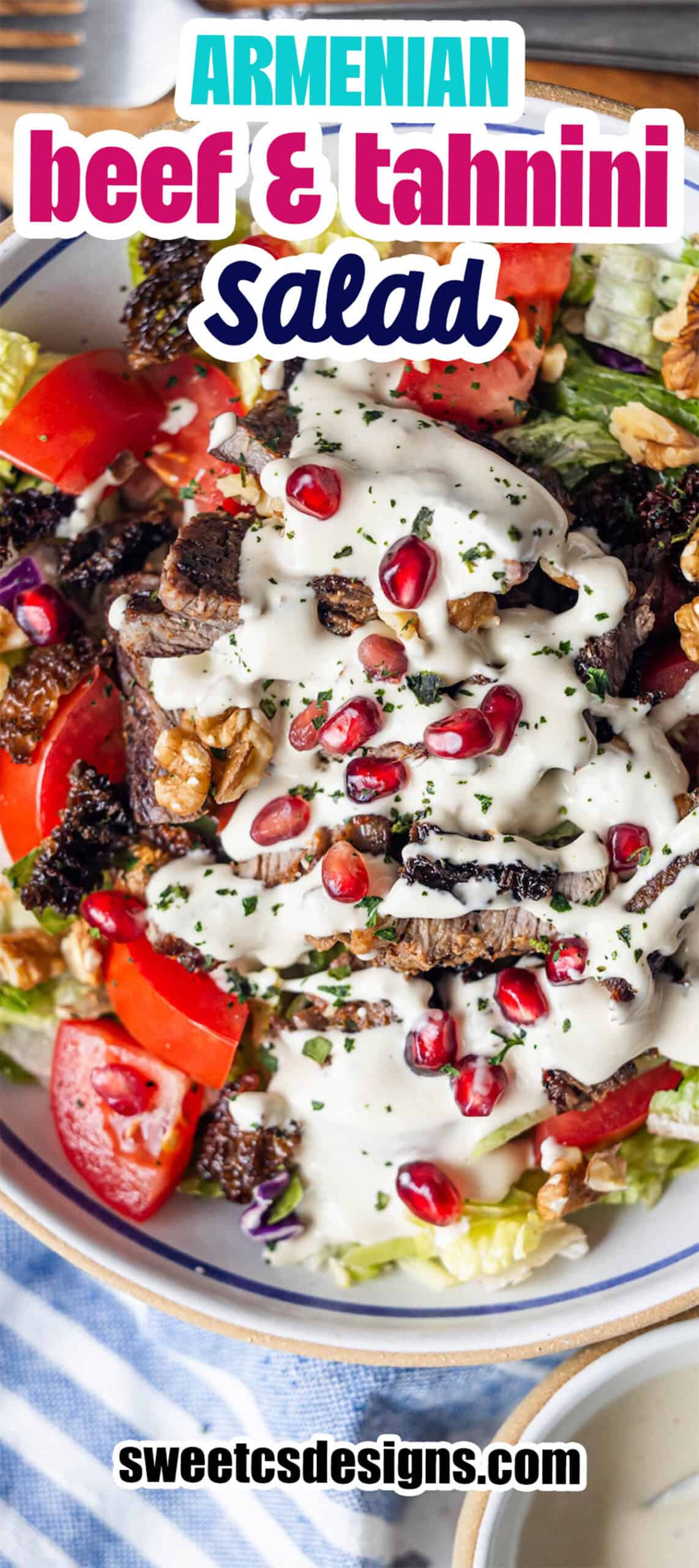 Bowl of Armenian beef and tahini salad with lettuce, tomatoes, walnuts, pomegranate seeds, and creamy dressing—a vibrant Armenian salad bursting with flavor.