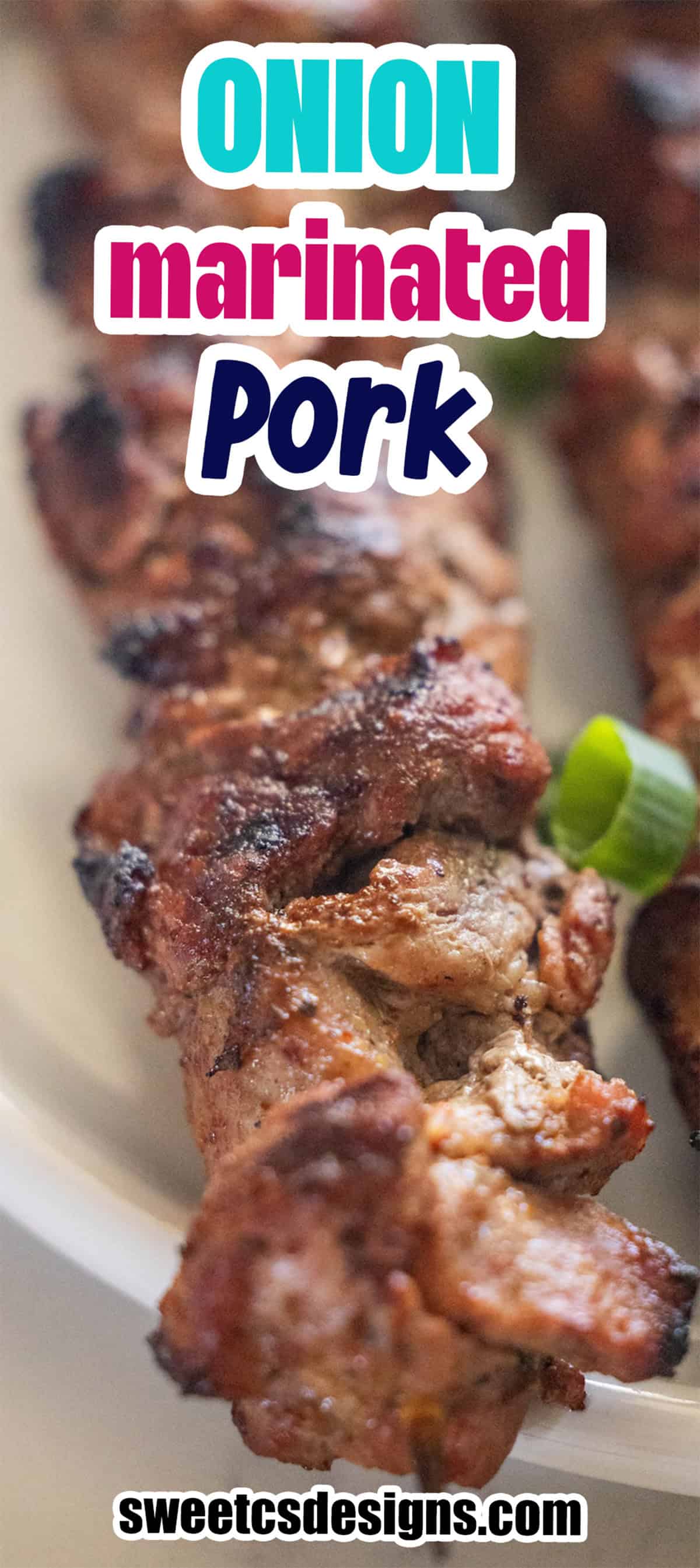 Grilled onion-marinated pork skewers served on a white plate.